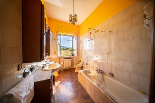 a bathroom with a tub and a sink and a bath tub at Cozy Room with Terrace, Ping Pong & Billiard Table in Monte Molino