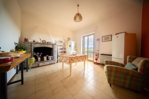 a living room with a table and a fireplace at Cozy Room with Terrace, Ping Pong & Billiard Table in Monte Molino