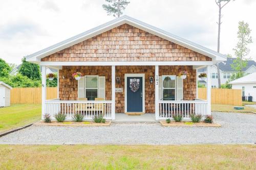 a small house with a blue door at Pet Friendly Cottage Near Historic Downtown & ILM in Wilmington