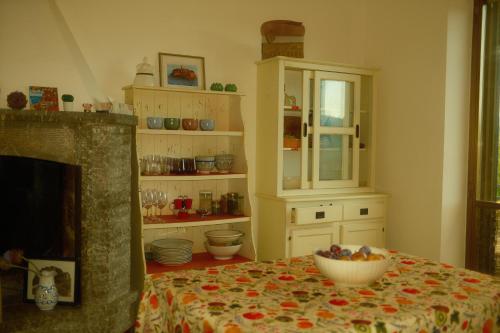 a kitchen with a table with a bowl of fruit on it at Cozy Room with Terrace, Ping Pong & Billiard Table in Monte Molino