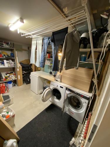 a laundry room with a washing machine in it at Private villa with hot tub in Skagaströnd
