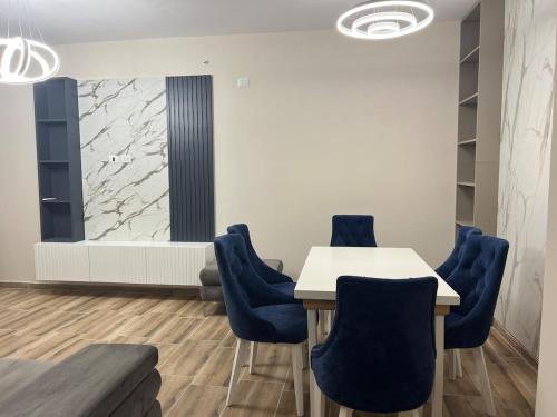 a meeting room with a table and blue chairs at SeaSide Escape in Durrës