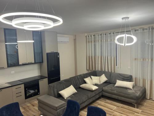 a living room with a couch and a table at SeaSide Escape in Durrës