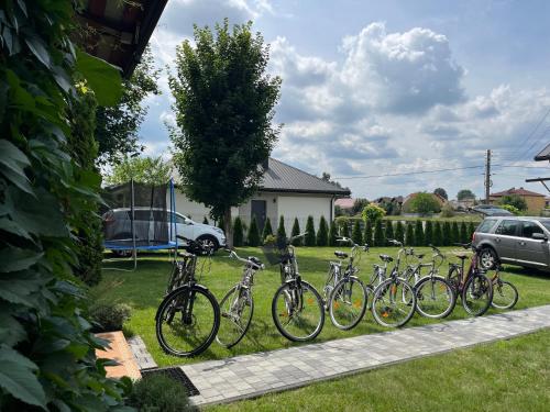 a row of bikes parked in a yard at Siedlisko pod Lasem in Józefów