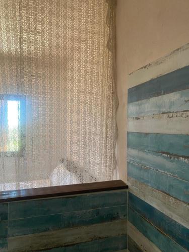 a room with a curtain and a window and a window at Vittò in Martina Franca