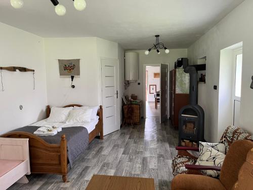 a bedroom with a bed and a living room at Siedlisko pod Lasem in Józefów