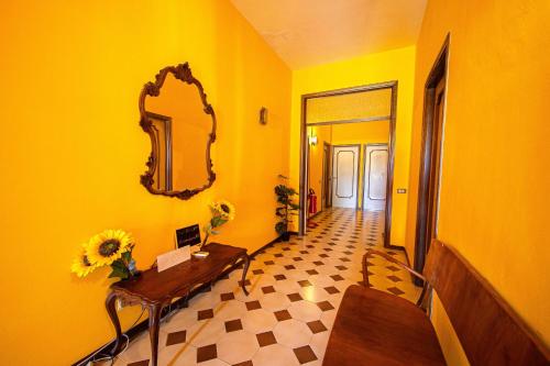 a yellow room with a table and a mirror at Cozy Room with Balcony, Ping Pong & Billiard Table in Monte Molino