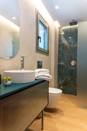 a bathroom with a sink and a toilet at Theoni House in Akrotiri