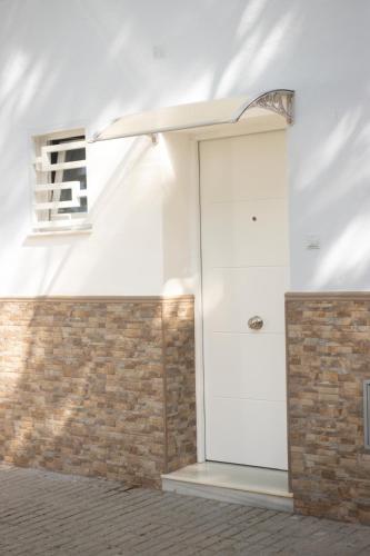 a white door in a room with a brick wall at Apartamento Jumar Costa del Sol in Torre del Mar