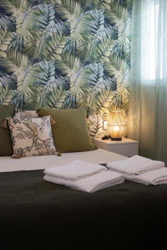 a bedroom with a bed with a blue and green wallpaper at Apartamento Jumar Costa del Sol in Torre del Mar