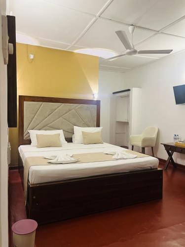 a bedroom with a large bed with a ceiling at Sky Garden Kandy in Kandy