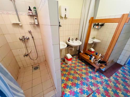 a bathroom with a shower and a sink and a tub at Torgu Royal Guesthouse in Iide