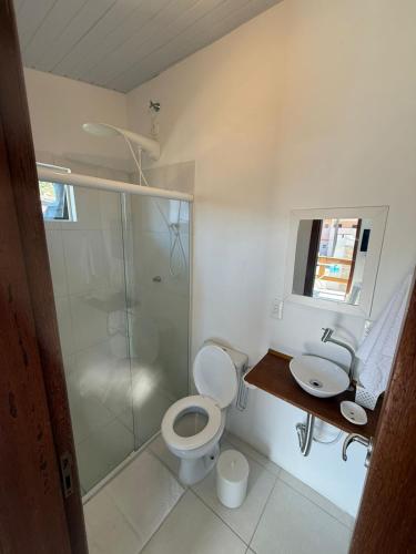 a bathroom with a shower and a toilet and a sink at Morada Silveira in Pinheiro