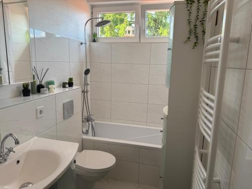 a bathroom with a toilet and a tub and a sink at Ferienwohnung im Harz 2 in Goslar