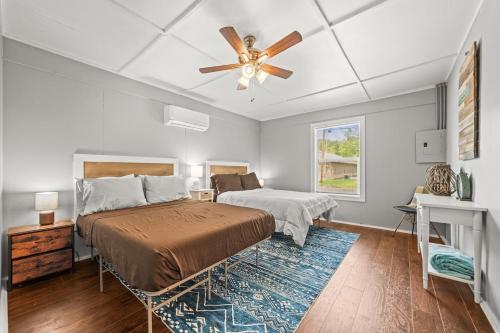 a bedroom with a bed and a ceiling fan at Cozy Retreat on Lake Catherine in Hot Springs