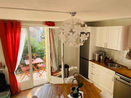 a kitchen with a chandelier in front of a window at Marie à Callas in Callas