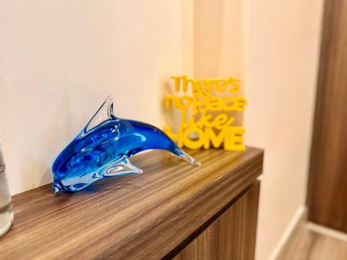 a blue glass bird sitting on top of a counter at Cocoon By Ichamati in Thākurdwari