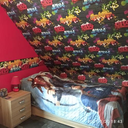 a bedroom with a wall covered in toy animals at alsacecoeur in Ungersheim