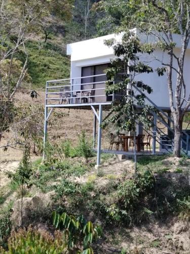 a house on top of a hill with a deck at Villas Entre Lagos in Lebrija