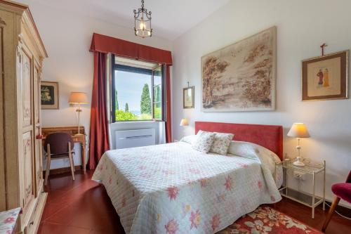 a bedroom with a bed and a large window at Villa Paradiso in Sirmione