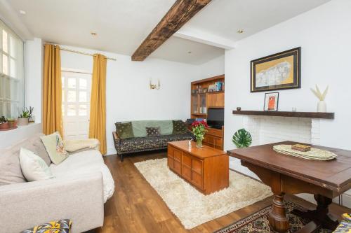 a living room with a couch and a table at Old Barrel Store - Old Town. Parking & Garden in Margate