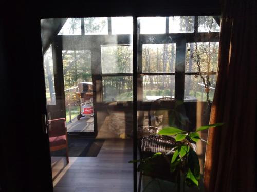 an open door to a room with a plant at The River Cabin in Mauston