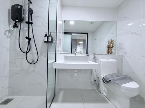 a bathroom with a sink and a toilet and a shower at Vetro11 Kota Kinabalu by LAXZONE in Kota Kinabalu