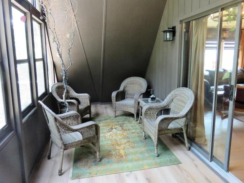 a group of chairs and tables in a room at The River Cabin in Mauston