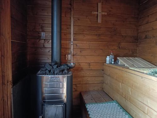 an outdoor stove in a wooden cabin with a counter at La Casa de mi Abuela in El Viso de San Juan