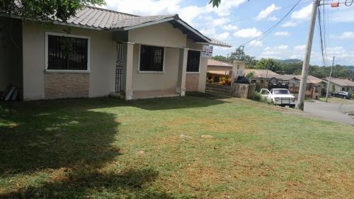 a house with a lawn in front of it at Entire house near the city of David in Los Algarrobos