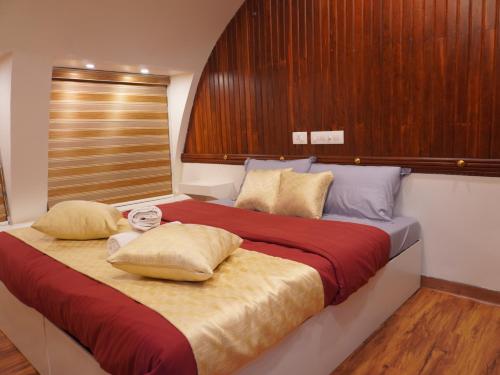 a bed with two pillows on it in a room at Alice Lake Promise in Alleppey