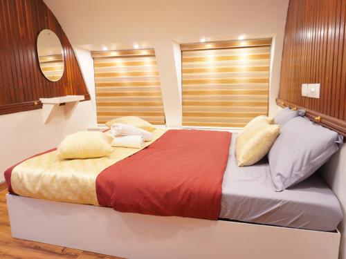 a bedroom with a large bed with two pillows at Alice Lake Promise in Alleppey