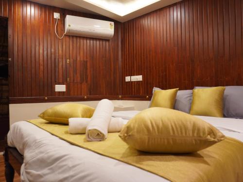 a bedroom with a bed with pillows on it at Alice Lake Promise in Alleppey