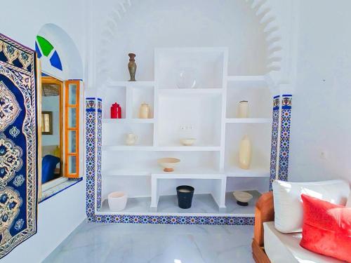 a room with white shelves with vases on them at Riad Casa Luafi in Tetouan