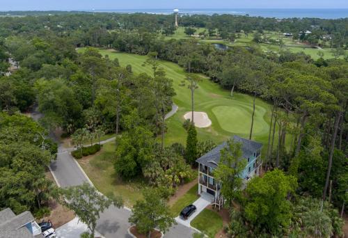 an aerial view of a golf course with a house at Experience Modern Coastal Living in this Beautifully Designed 4-Bed, 4-Bath Home in Fripp Island