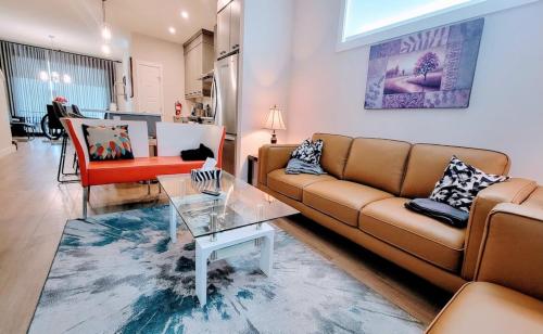a living room with a couch and a table at Brand New 3-Bedroom Home in a Quiet Neighborhood in Calgary