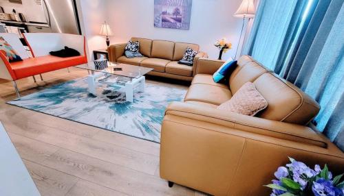 a living room with a couch and a table at Brand New 3-Bedroom Home in a Quiet Neighborhood in Calgary