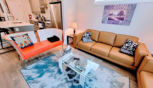 a living room with a couch and a glass table at Brand New 3-Bedroom Home in a Quiet Neighborhood in Calgary