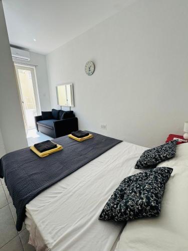 a bedroom with a large bed with two pillows on it at Central and Modern Apartment St Julians in St Julian's