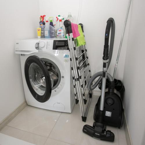 a washer and dryer in a laundry room at Balkan Tower Deluxe Candy in Gabrovo