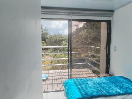 a bedroom with a window with a view of a balcony at Villas Entre Lagos in Lebrija