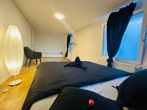 a bedroom with two beds and a large window at Exklusives Apartment mit traumhaftem Seeblick & Balkon in Rorschach