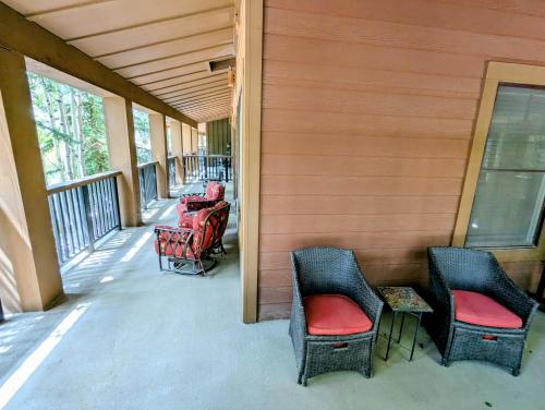 a porch with three chairs and a table on a house at Springs 8822 by SummitCove Lodging in Keystone