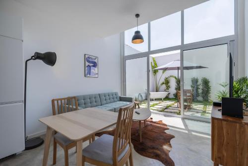 a living room with a table and a couch at Poets Atelier in Oeiras