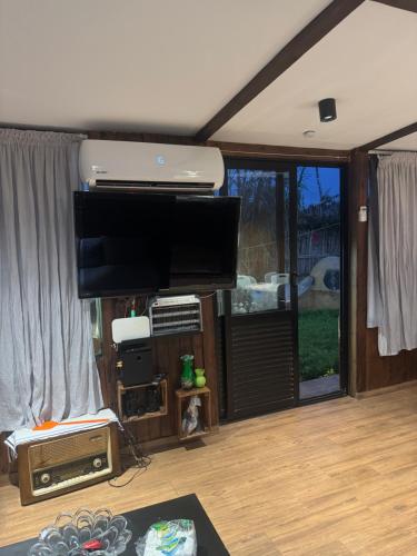 a living room with a flat screen tv on the wall at Casa del campo in Souani