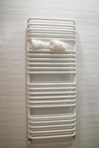 a white towel rack with two white towels at Lipowa Apartamenty B in Szczawno-Zdrój