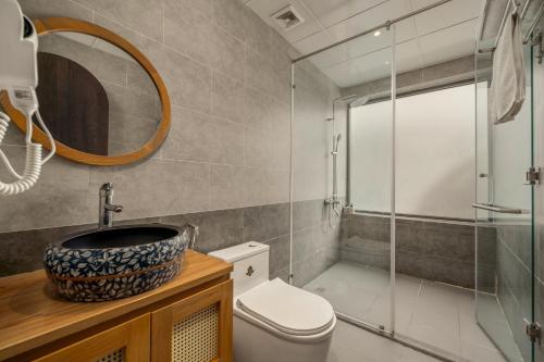 a bathroom with a sink and a toilet and a shower at Tropical An Bang Beach Villa in Hoi An