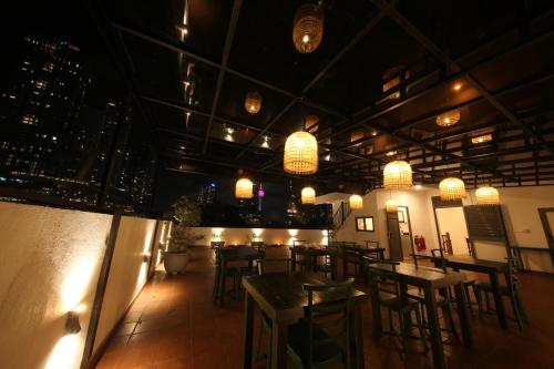 a restaurant with tables and chairs and lights at Seilan in Colombo