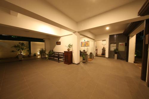an empty lobby with a table and potted plants at Seilan in Colombo