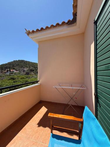 a room with a balcony with a bench and a view at The Twin Houses in Metamórfosis